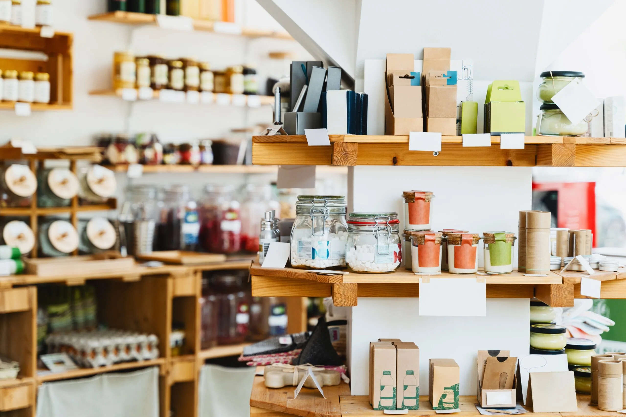 Wooden retail shelves displaying jars and packaged specialty products.