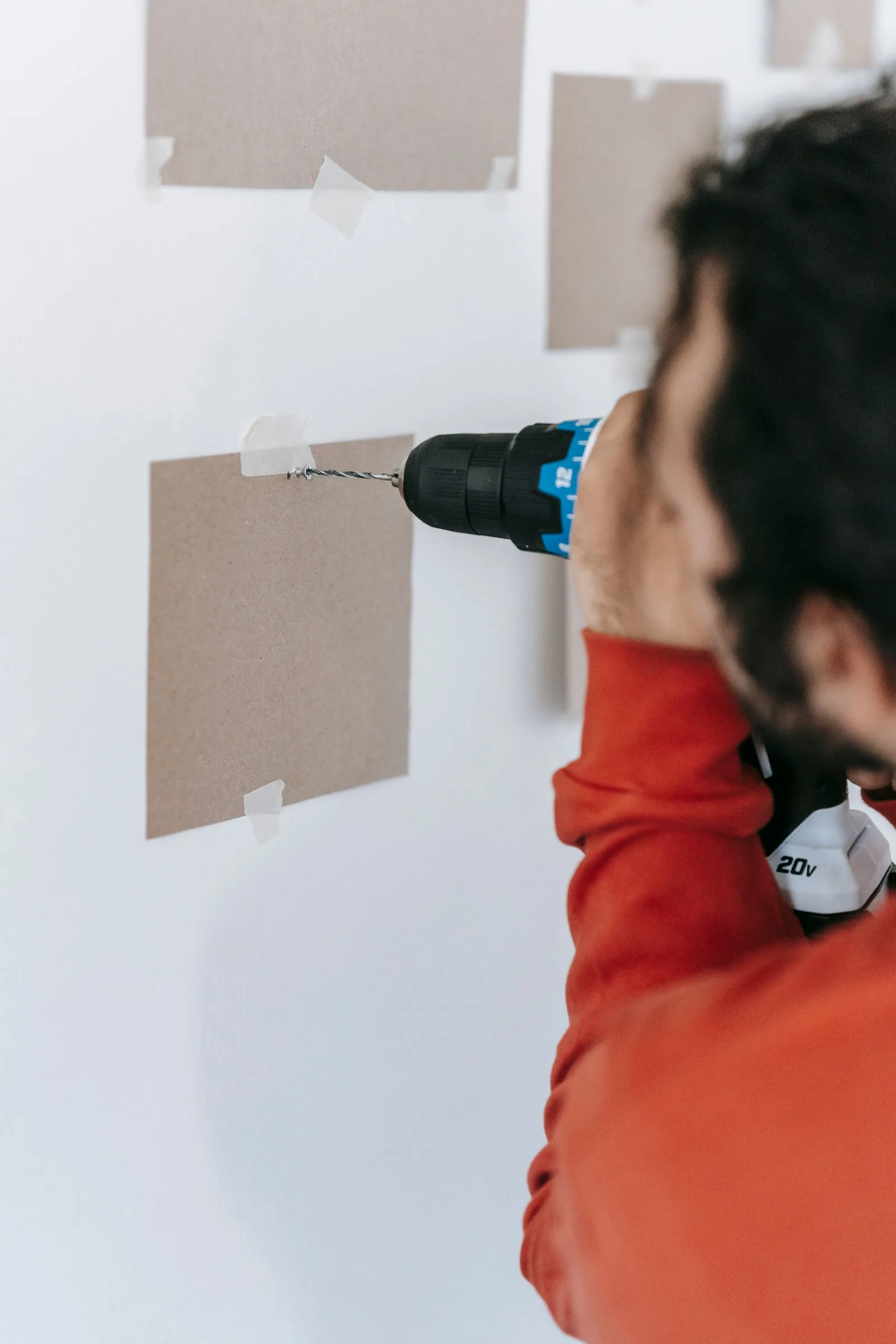 Home improvement professional using a power drill for an interior repair