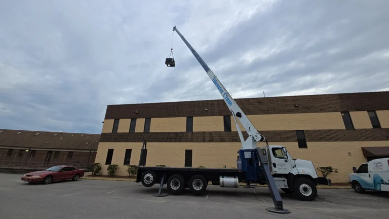 Crane lifting rooftop equipment during an E&H Mechanical commercial HVAC project.