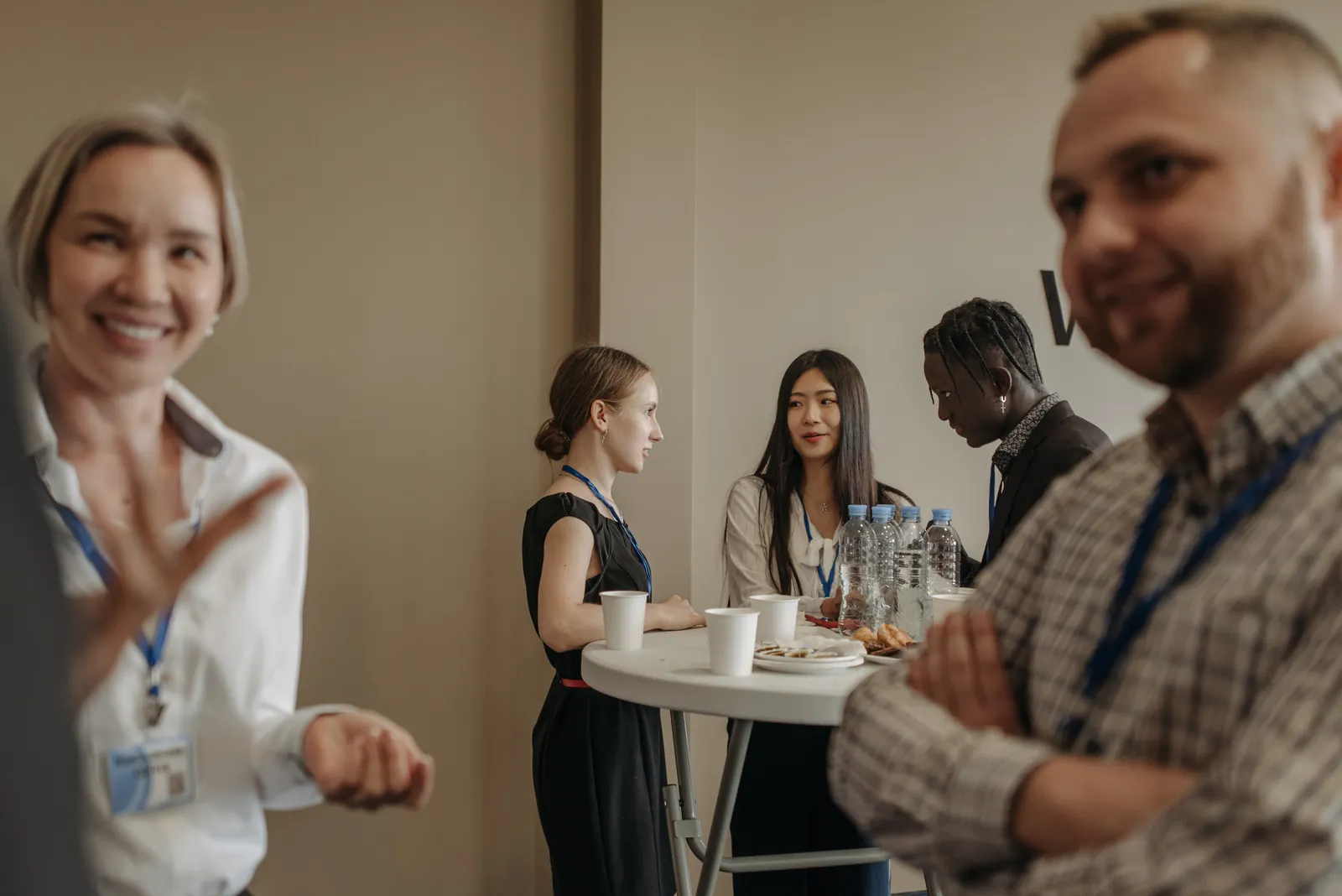 Adults talking over refreshments during a business networking break.