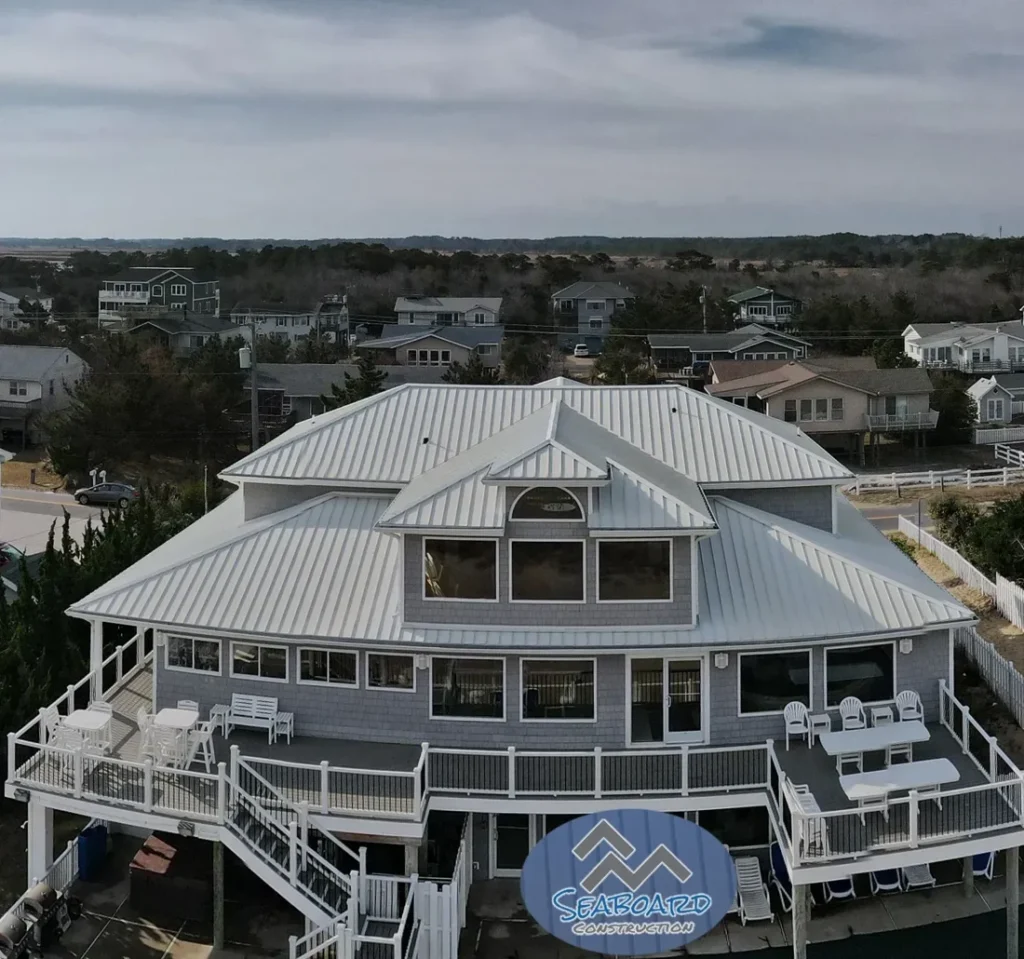 Coastal home with a silver metal roof and wraparound porches in Seaboard Construction’s project gallery