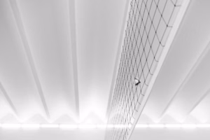 Volleyball above an indoor net; illustrative photograph